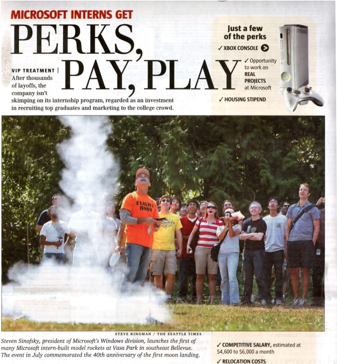 Newspaper article showing "Perks, Pay, Play" and a group of micrsoft interns launching model rockets. I am at the controls. It is summer and looks fun.